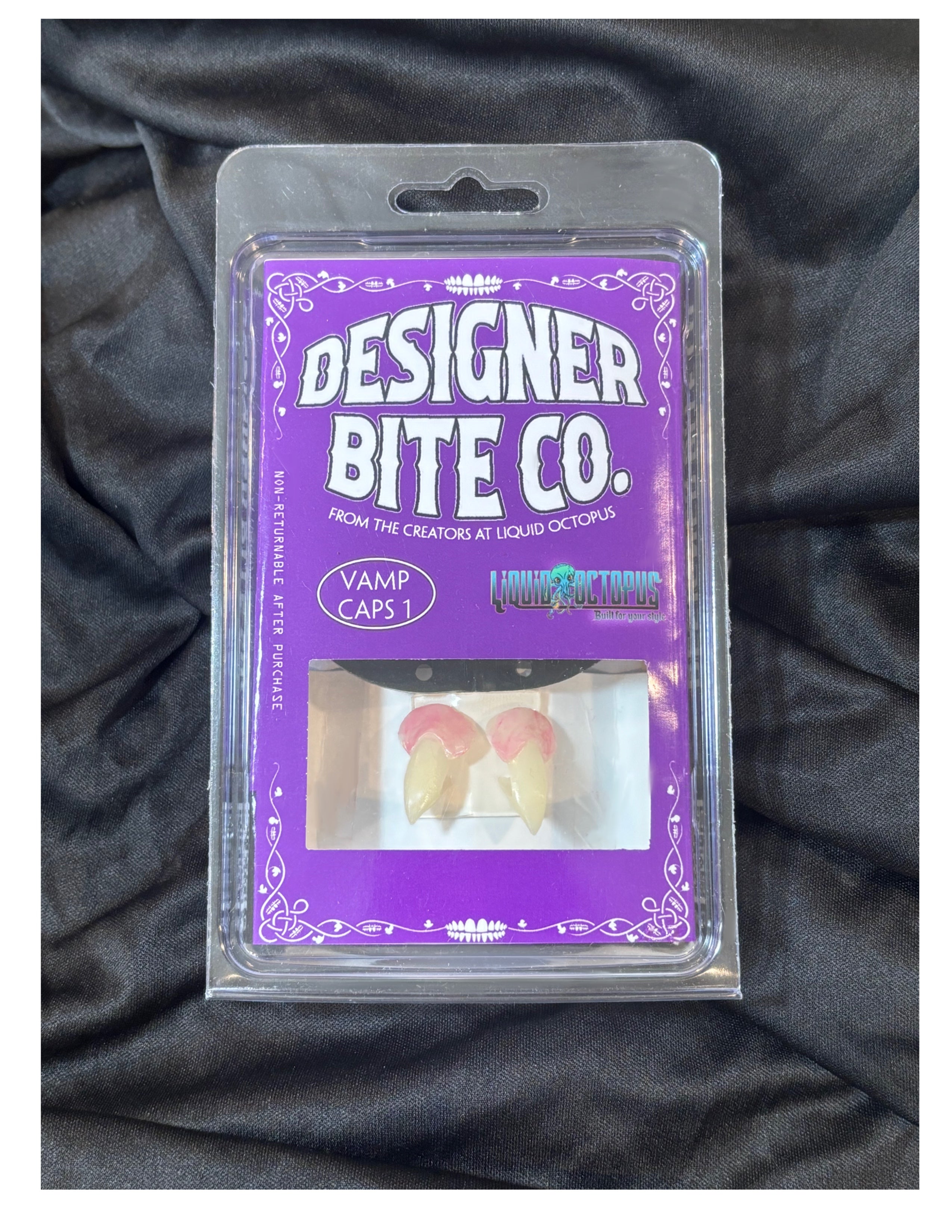Designer Bite Co realistic vampire fang caps in retail clamshell packaging with reusable fitting kit